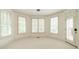Sunlit room features large windows with shutters, neutral decor, and access to the outdoors at 9202 Arlington Hills Dr, Mint Hill, NC 28227