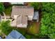 Aerial view of a home with a backyard deck, a defined garden and mature tree coverage at 9410 Greenbank Ct, Charlotte, NC 28214