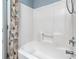 This bathroom showcases a white tiled tub with shower features at 9410 Greenbank Ct, Charlotte, NC 28214