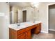 Bright bathroom features a double sink vanity, large mirror, and tiled floors at 9410 Greenbank Ct, Charlotte, NC 28214