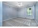 A spacious bedroom with a ceiling fan, neutral walls, and large window at 9410 Greenbank Ct, Charlotte, NC 28214