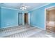 A blue carpeted bedroom has three doors with a ceiling fan at 9410 Greenbank Ct, Charlotte, NC 28214