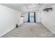 Bonus room offers versatile space with neutral carpet, window, and wall shelves at 9410 Greenbank Ct, Charlotte, NC 28214