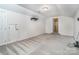Bonus room offers versatile space with neutral carpet, window, and wall shelves at 9410 Greenbank Ct, Charlotte, NC 28214