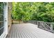 Spacious wooden deck showcases ample space for outdoor lounging and entertainment, bordered by lush greenery at 9410 Greenbank Ct, Charlotte, NC 28214