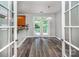 Bright dining area with access to a deck, modern light fixture, and view into the kitchen at 9410 Greenbank Ct, Charlotte, NC 28214