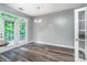 An empty dining room with hardwood style flooring and french doors to the outside at 9410 Greenbank Ct, Charlotte, NC 28214
