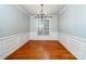 Formal dining room features beautiful hardwood floors, wainscoting, and a chandelier at 9410 Greenbank Ct, Charlotte, NC 28214