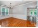 Elegant dining room with hardwood floors, wainscoting, and a classic chandelier at 9410 Greenbank Ct, Charlotte, NC 28214