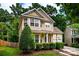 Well-maintained two-story home featuring a lush green lawn and mature trees at 9410 Greenbank Ct, Charlotte, NC 28214