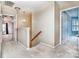 Upstairs hallway landing with a wooden railing and access to the bedrooms at 9410 Greenbank Ct, Charlotte, NC 28214