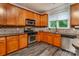 Well-lit kitchen with wood cabinets, stainless steel appliances, and a window view at 9410 Greenbank Ct, Charlotte, NC 28214