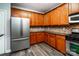 A bright kitchen featuring stainless steel appliances and hardwood style floors at 9410 Greenbank Ct, Charlotte, NC 28214