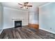 Open living room with a fireplace, hardwood flooring, and neutral paint for versatile decor at 9410 Greenbank Ct, Charlotte, NC 28214