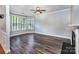 Comfortable living room featuring a cozy fireplace, crown molding, and large windows for natural light at 9410 Greenbank Ct, Charlotte, NC 28214