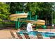 Image of the waterslide at the community pool, surrounded by chairs and landscaping at 9410 Greenbank Ct, Charlotte, NC 28214
