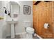 Charming half bathroom with decorative wood wall paneling and sleek fixtures at 1005 Exodus Ct, Monroe, NC 28110