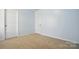 Empty bedroom shows two doors and neutral carpet at 1005 Exodus Ct, Monroe, NC 28110