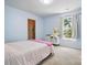 This bedroom features a stuffed animal, a window and a walk in closet at 1005 Exodus Ct, Monroe, NC 28110