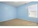 Clean bedroom features neutral carpet and a window with blinds for privacy at 1005 Exodus Ct, Monroe, NC 28110