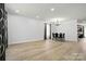Spacious dining area with modern flooring, chandelier, and a full view of the adjacent living spaces at 1005 Exodus Ct, Monroe, NC 28110