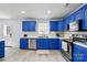 Beautiful kitchen features stainless steel appliances, stylish blue cabinets, and marble countertops at 1005 Exodus Ct, Monroe, NC 28110