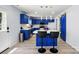 Charming kitchen featuring bright blue cabinets, a modern island with seating and stainless steel appliances at 1005 Exodus Ct, Monroe, NC 28110