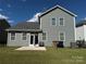 Backyard view of a well-maintained home with a patio and a manicured lawn at 1016 Laggan Ln, Indian Trail, NC 28079