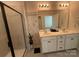Modern bathroom featuring double sinks, white cabinetry, and a glass shower at 1016 Laggan Ln, Indian Trail, NC 28079
