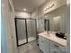 This modern bathroom has a glass shower, and a sink with white cabinets at 1016 Laggan Ln, Indian Trail, NC 28079