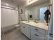 Well-lit bathroom featuring a white vanity, a large mirror, and a shower-tub combination at 1016 Laggan Ln, Indian Trail, NC 28079