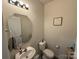 Charming half-bathroom featuring a mirror, vanity, and a soothing color palette at 1016 Laggan Ln, Indian Trail, NC 28079