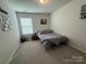 Well-lit bedroom featuring carpeting, a window, and simple decor, creating a cozy atmosphere at 1016 Laggan Ln, Indian Trail, NC 28079