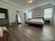 Spacious main bedroom features neutral walls, hard wood floors, and a large mirror at 1016 Laggan Ln, Indian Trail, NC 28079