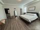 A bright bedroom features hardwood floors, a modern bed frame, and neutral walls at 1016 Laggan Ln, Indian Trail, NC 28079