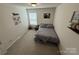 Simple bedroom featuring a bed, soft carpeting, and a window, creating a cozy space at 1016 Laggan Ln, Indian Trail, NC 28079