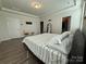 Bright bedroom featuring hardwood floors, a closet, and a modern bed frame at 1016 Laggan Ln, Indian Trail, NC 28079