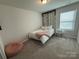 Cozy bedroom featuring a twin bed, and a bright window, creating a welcoming atmosphere at 1016 Laggan Ln, Indian Trail, NC 28079