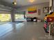 Spacious garage with ample room for parking and storage or a home gym, with a well-lit interior at 1016 Laggan Ln, Indian Trail, NC 28079