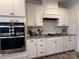 Modern kitchen with stainless steel appliances, white cabinetry, and a stylish backsplash for a sleek design at 1016 Laggan Ln, Indian Trail, NC 28079