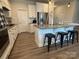 Modern kitchen island with granite countertops, seating for three, and stainless steel appliances at 1016 Laggan Ln, Indian Trail, NC 28079
