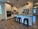 Open kitchen with white cabinets, stainless steel appliances, granite countertops, and a functional island at 1016 Laggan Ln, Indian Trail, NC 28079