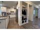 Bright kitchen featuring modern white cabinets, stainless steel appliances, and an adjacent mudroom area at 1016 Laggan Ln, Indian Trail, NC 28079