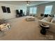 A spacious living room features a ceiling fan, plentiful seating and natural light at 1016 Laggan Ln, Indian Trail, NC 28079