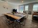 Open-concept living room featuring a modern table, chairs, and ample natural light at 1016 Laggan Ln, Indian Trail, NC 28079