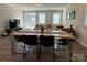 Bright living room featuring an open floorplan and table with modern black chairs at 1016 Laggan Ln, Indian Trail, NC 28079