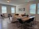 Cozy living area with ample natural light, comfortable seating, and a modern dining table at 1016 Laggan Ln, Indian Trail, NC 28079