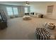 A spacious living room featuring plentiful seating and natural light from several windows at 1016 Laggan Ln, Indian Trail, NC 28079