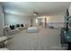 This spacious living room features a ceiling fan, plentiful seating, and a staircase at 1016 Laggan Ln, Indian Trail, NC 28079
