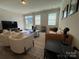 Inviting living room featuring hardwood floors, natural light, and a comfortable seating arrangement at 1016 Laggan Ln, Indian Trail, NC 28079